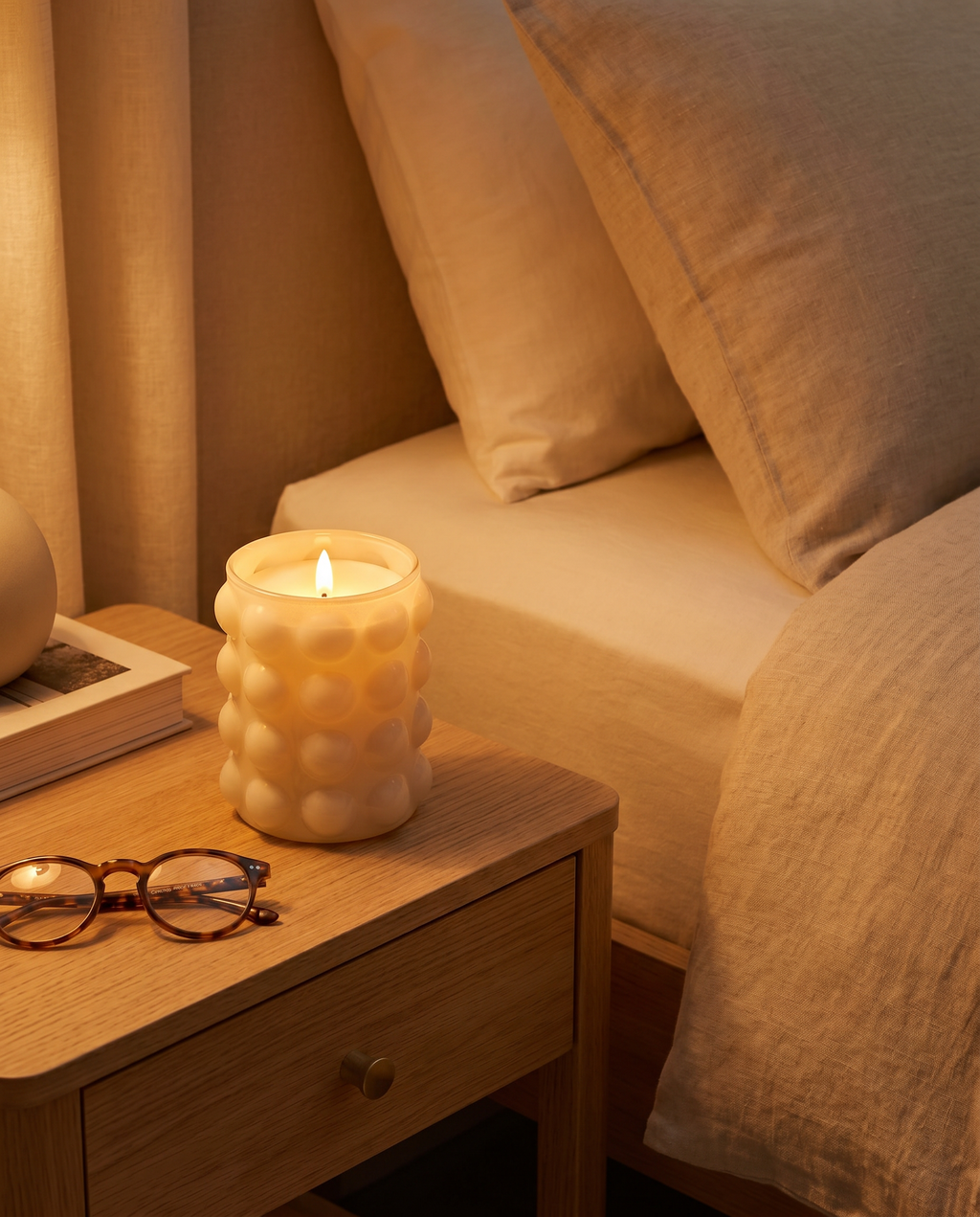 Emberless flameless candle glowing on a nightstand at night, safe and flame-free
