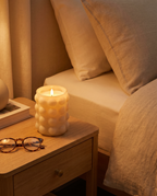 Emberless flameless candle glowing on a nightstand at night, safe and flame-free